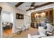 Stylish wet bar with custom cabinets, a wine fridge, stone accents, and seating perfect for entertaining guests at 4008 Saint Andrews Ct, Cramerton, NC 28032