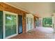 Charming front porch with brick flooring, decorative columns, black shutters, and a house number at 406 Forest Dr, York, SC 29745