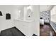 Bathroom featuring a double vanity with mirrors and black tile floors at 4106 Castlewood Rd, Charlotte, NC 28209