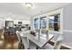 Dining room with hardwood floors, views to the kitchen, stylish chairs, and natural light from large windows at 4106 Castlewood Rd, Charlotte, NC 28209