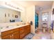 Bright bathroom featuring a double vanity and a colorful shower curtain at 431 Island Cove Rd # 86, Norwood, NC 28128
