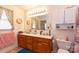 Well-lit bathroom with a double vanity, wooden cabinets, and decorative elements at 431 Island Cove Rd # 86, Norwood, NC 28128