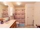Bathroom with a wood vanity, neutral walls, and a shower with colorful curtain at 431 Island Cove Rd # 86, Norwood, NC 28128