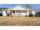 Charming one story home featuring a cozy front porch with benches and well-maintained landscaping on a spacious lot at 431 Island Cove Rd # 86, Norwood, NC 28128