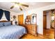 Bedroom with hardwood floors, ceiling fan, and dresser with mirror at 510 W 15Th St, Newton, NC 28658