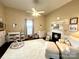 Cozy bedroom featuring a decorative fireplace, plush carpet, and natural light at 5124 Old Mountain Rd, Stony Point, NC 28678