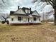 Classic two-story home with a welcoming front porch and traditional architectural details at 5124 Old Mountain Rd, Stony Point, NC 28678