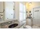 Bright bathroom with granite countertops, white cabinets, and a shuttered window at 610 Walnut St, Statesville, NC 28677