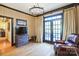 Cozy living room with hardwood floors, french doors, and a comfortable leather armchair at 610 Walnut St, Statesville, NC 28677