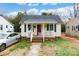 Charming single-story home with a cozy front porch and well-lit pathway at 642 E Black St, Rock Hill, SC 29730