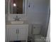 Bathroom featuring a white sink vanity, toilet, and framed mirror at 6434 Miller Rd, Kannapolis, NC 28081