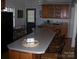 Kitchen island with breakfast bar seating, wood cabinets and countertops, and views to the exterior at 6434 Miller Rd, Kannapolis, NC 28081