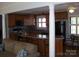 Eat-in kitchen featuring wood cabinets, breakfast bar seating, and natural light from the window at 6434 Miller Rd, Kannapolis, NC 28081