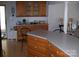 Inviting kitchen featuring wood cabinetry, laminate countertops, and seamless flow to living area at 6434 Miller Rd, Kannapolis, NC 28081