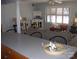 Open-concept living room featuring wood floors, shuttered windows, and a cozy seating arrangement at 6434 Miller Rd, Kannapolis, NC 28081