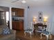 Living room featuring decorative white chairs and accent lighting, with doorway access to the exterior at 6434 Miller Rd, Kannapolis, NC 28081