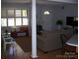 Bright living room with hardwood floors, shuttered windows, and comfortable seating area at 6434 Miller Rd, Kannapolis, NC 28081