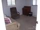 Cozy living room features a plush sofa, accent chair, and classic wooden dresser at 6434 Miller Rd, Kannapolis, NC 28081