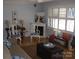 Inviting living room with a decorative fireplace, cozy seating, and natural light from shuttered windows at 6434 Miller Rd, Kannapolis, NC 28081