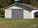 A practical storage building, perfect for hobbies or equipment, surrounded by a grassy lawn at 6434 Miller Rd, Kannapolis, NC 28081