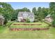Stunning aerial view of a home showcasing a tiered deck, lush landscaping, and fenced-in yard at 7191 Grist Mill Ct, Denver, NC 28037