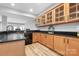 Basement bar area featuring black countertops and wooden cabinets at 7191 Grist Mill Ct, Denver, NC 28037