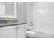 Cozy bathroom featuring tiled shower over tub, gray counters and white cabinets at 7191 Grist Mill Ct, Denver, NC 28037