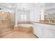 Bright bathroom with a glass-enclosed shower, soaking tub, and white cabinetry with granite countertops at 7191 Grist Mill Ct, Denver, NC 28037