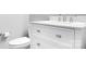 Modern bathroom featuring a white vanity with marble countertop and modern fixtures, complemented by a toilet at 7191 Grist Mill Ct, Denver, NC 28037