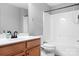 Bright bathroom with white tub and shower, plus wooden vanity for ample storage at 7191 Grist Mill Ct, Denver, NC 28037