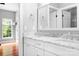 Modern bathroom featuring double sinks with marble counters and white cabinets at 7191 Grist Mill Ct, Denver, NC 28037