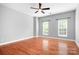 Expansive bedroom featuring hardwood floors, gray walls and two windows at 7191 Grist Mill Ct, Denver, NC 28037