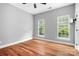 Clean bedroom featuring hardwood floors, gray walls and two windows at 7191 Grist Mill Ct, Denver, NC 28037