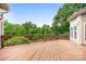 Expansive wooden deck offering a tranquil view of the surrounding lush greenery, perfect for outdoor relaxation at 7191 Grist Mill Ct, Denver, NC 28037
