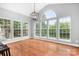 Bright dining area with hardwood floors, large windows offering scenic views of the outdoors at 7191 Grist Mill Ct, Denver, NC 28037
