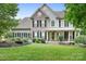 Charming two-story home with stone accents, a welcoming porch, and a beautifully landscaped front yard at 7191 Grist Mill Ct, Denver, NC 28037