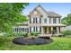 Charming two-story home with stone accents, a welcoming porch, and a beautifully landscaped front yard at 7191 Grist Mill Ct, Denver, NC 28037