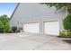 Spacious two-car garage with white doors and ample parking space on a concrete driveway at 7191 Grist Mill Ct, Denver, NC 28037