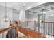 Hallway with coffered ceilings, decorative railings, and an elegant chandelier offering a grand entrance at 7191 Grist Mill Ct, Denver, NC 28037
