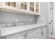 Close-up of kitchen's sleek white cabinets and luxurious marble countertops, with stainless steel hardware at 7191 Grist Mill Ct, Denver, NC 28037