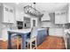 Stylish kitchen with a central island featuring seating, modern appliances, and elegant cabinetry at 7191 Grist Mill Ct, Denver, NC 28037