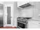 Well-equipped kitchen featuring stainless steel appliances, gas range, and custom white cabinetry at 7191 Grist Mill Ct, Denver, NC 28037
