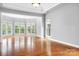 Spacious living room featuring hardwood floors, large windows and stylish ceiling with crown molding at 7191 Grist Mill Ct, Denver, NC 28037