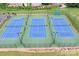 Aerial view of well-maintained tennis courts, provides ample opportunities for recreation at 7191 Grist Mill Ct, Denver, NC 28037