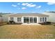 Backyard of home featuring sliding glass doors, grass, landscaping and sunny sky at 7203 Shenandoah Dr, Fort Mill, SC 29707
