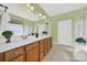 Bathroom featuring double sinks, wood cabinets, and a large vanity mirror at 7203 Shenandoah Dr, Fort Mill, SC 29707