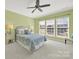 Bright bedroom with three windows, a ceiling fan, and neutral carpeting at 7203 Shenandoah Dr, Fort Mill, SC 29707