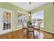 Sun-filled breakfast nook with a glass table, four chairs, and three large windows at 7203 Shenandoah Dr, Fort Mill, SC 29707