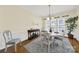 Sunny dining room boasts classic wainscoting, hardwood floors, and a view to the living room at 7203 Shenandoah Dr, Fort Mill, SC 29707
