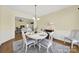 Bright dining room features hardwood floors, a view to the living room, and stylish décor at 7203 Shenandoah Dr, Fort Mill, SC 29707